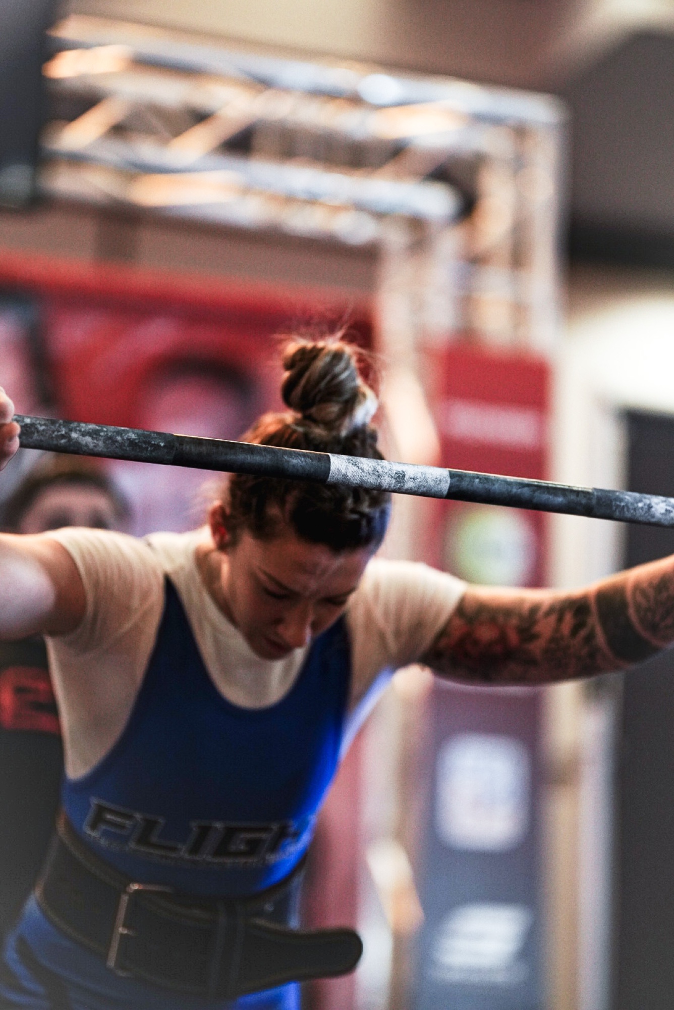 Alex Hubelbank under a loaded barbell, mid-squat.